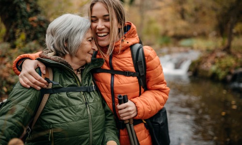 a couple of women smiling while hiking